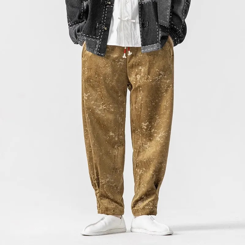 Casual model wearing crushed velvet joggers with elastic cuffs and drawstring waist in a stylish neutral tone.