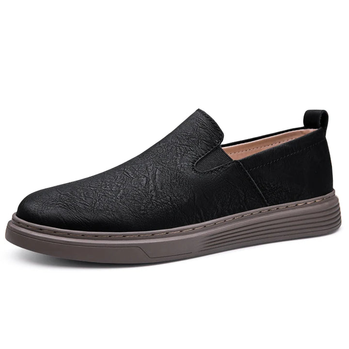 Duke Leather Slip-On Shoes in black, crafted from genuine leather with a cushioned sole and elastic side panels for comfort.