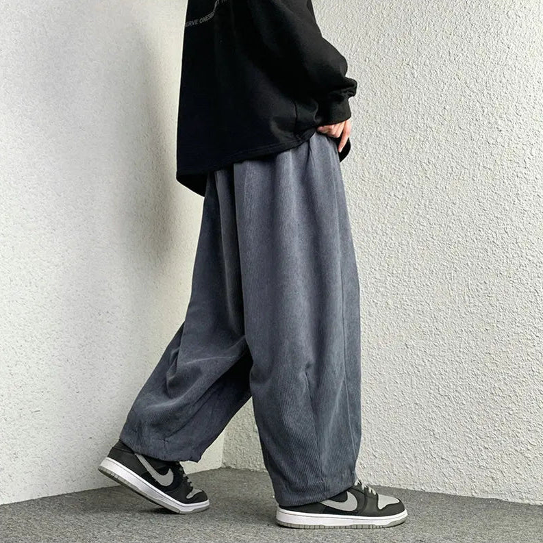 Model wearing relaxed-fit Arlo corduroy pants, showcasing wide-leg style and casual streetwear look.