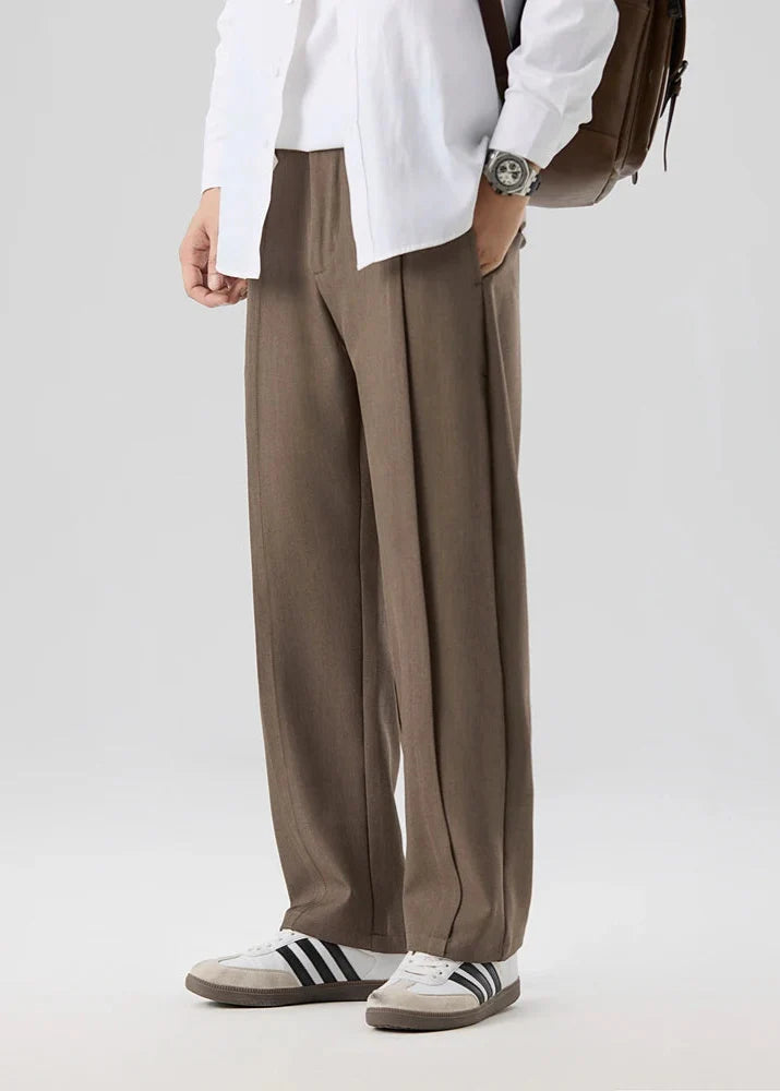 Man wearing Calloway Pleated Trousers, showcasing relaxed straight-leg fit and elegant pleated front.