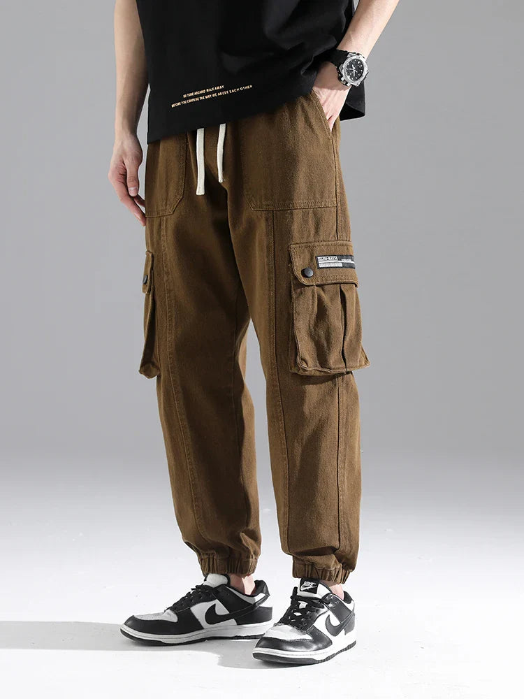 Lennox Cargo Joggers in brown, featuring deep cargo pockets, gathered cuffs, and a relaxed tapered fit.