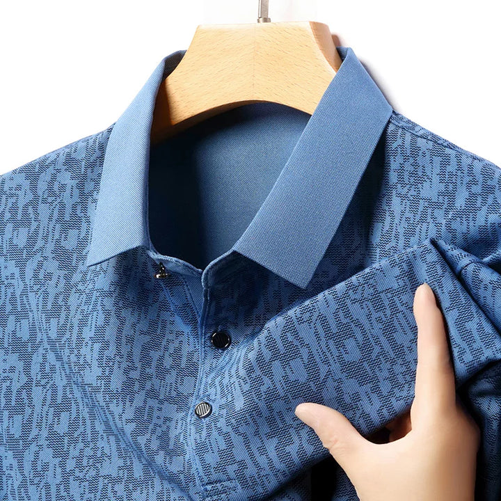 Close-up of Auren Men's Jacquard Polo Shirt in blue, showcasing textured fabric and structured collar.