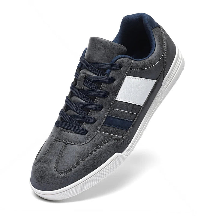 Rival Sport Sneakers in gray and navy with contrast paneling, offering retro style and modern comfort for everyday wear.