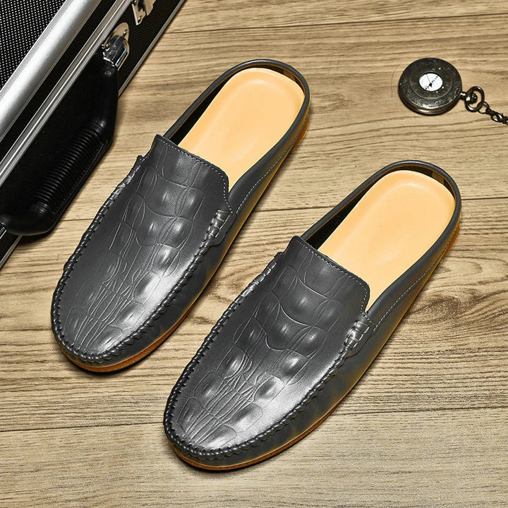 Gianni backless slide loafers in grey with embossed upper and classic moc toe for stylish comfort.