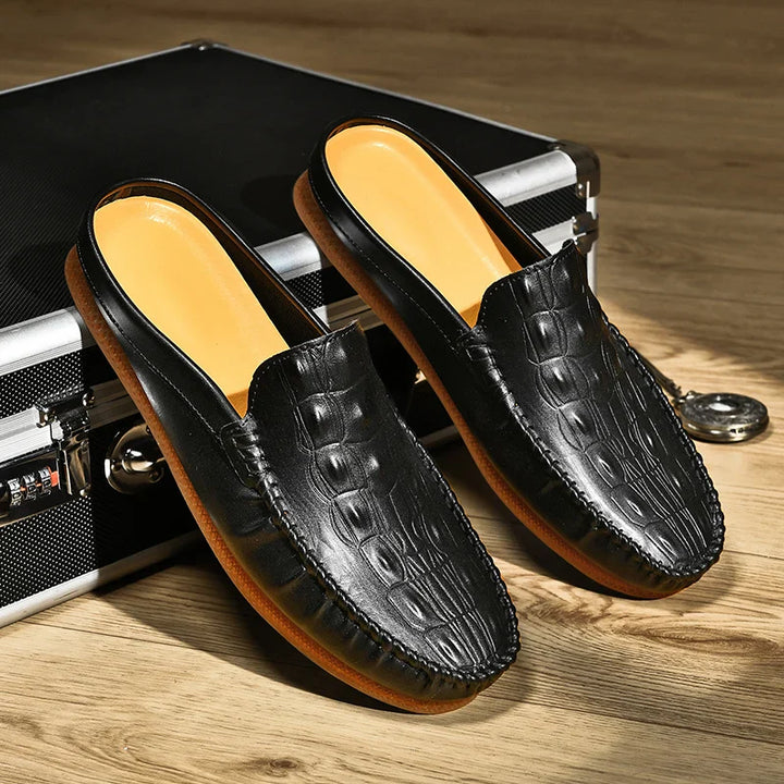 Gianni backless slide loafers in black embossed leather with cushioned insole and classic moc toe style.