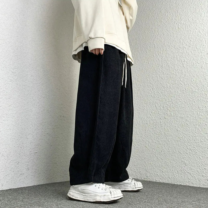 Comfortable Arlo Corduroy Pants with wide-leg fit, adjustable drawstring waist, and deep pockets, styled with a relaxed top.