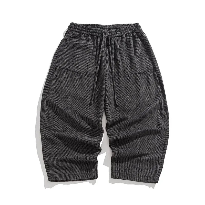 Henderson wide-leg corduroy pants in dark gray with gathered elastic waistband and deep pleats for a relaxed fit.