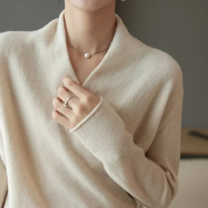 Wrap-front cream wool sweater with relaxed fit, perfect for comfort and effortless style.