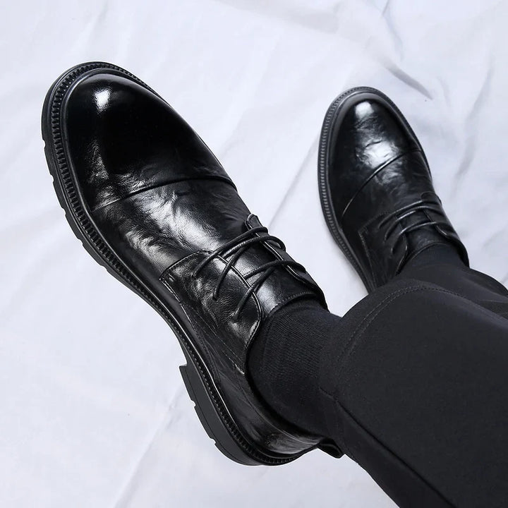 Soren genuine leather shoes showcasing a polished black finish, lace-up design, and durable rubber sole for everyday comfort.