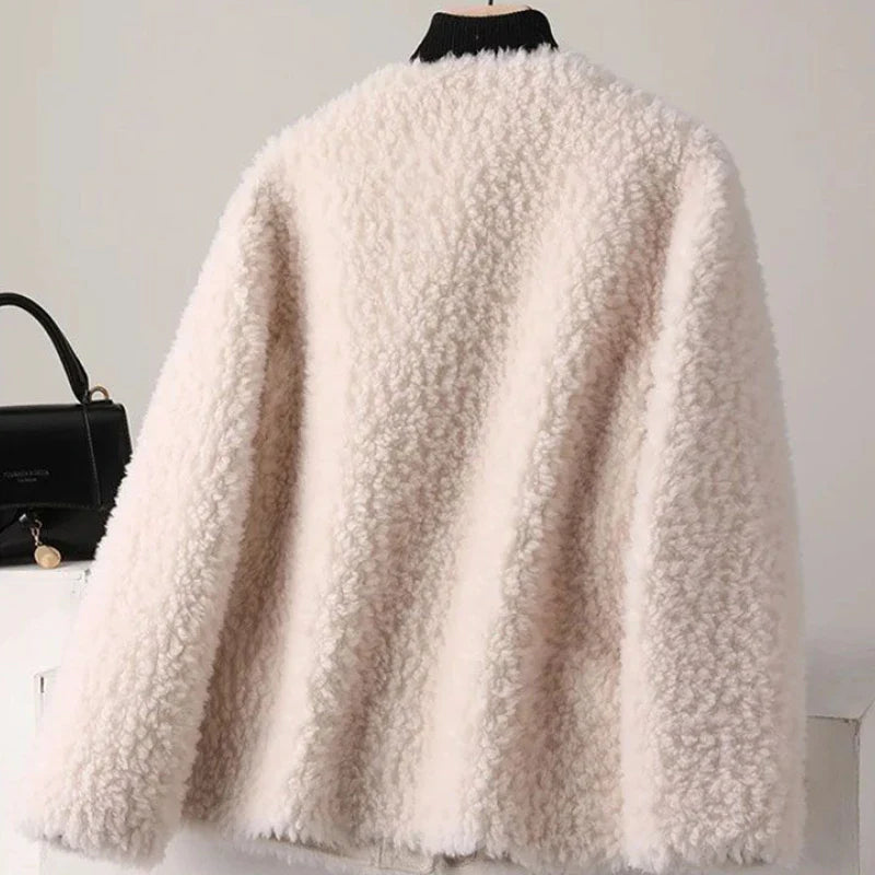White fluffy coat on a mannequin with a black handbag in the background