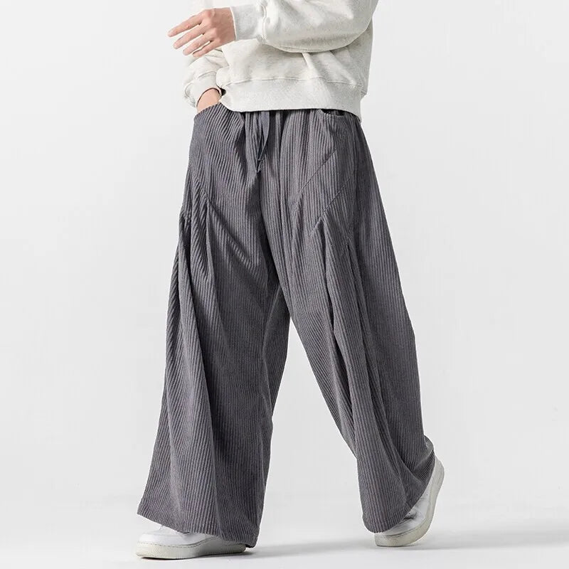 Hollis Corduroy Pants: Wide-leg, soft corduroy trousers with deep pleats and smooth elastic waistband for a stylish fit.