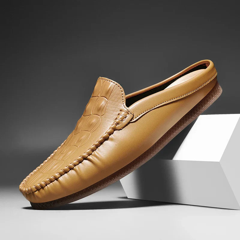 Gianni backless slide loafers in tan with embossed upper and classic moc toe design for comfortable daily wear.
