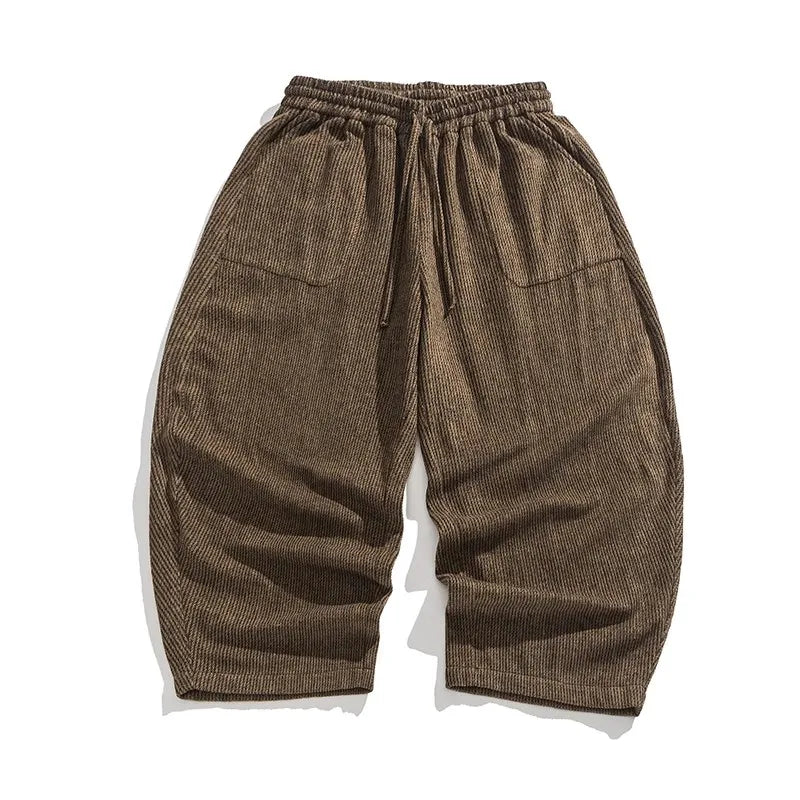 Henderson corduroy pants in a warm brown color, featuring a gathered elastic waistband and wide-leg silhouette.