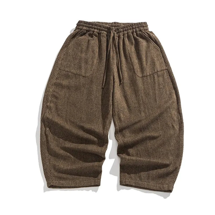 Henderson corduroy pants in a warm brown color, featuring a gathered elastic waistband and wide-leg silhouette.