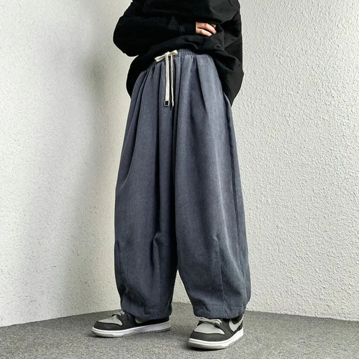 Arlo Corduroy Pants with wide-leg fit, adjustable drawstring waist, and deep pockets showcased in a relaxed style.