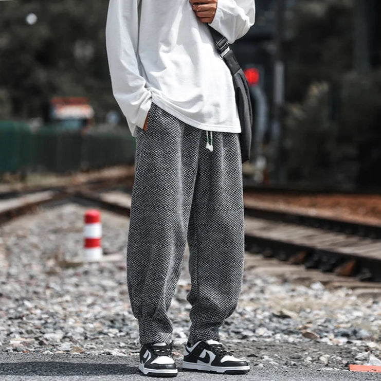 Oslo Textured Joggers in a relaxed fit on a model, styled with a white long-sleeve shirt and sneakers.