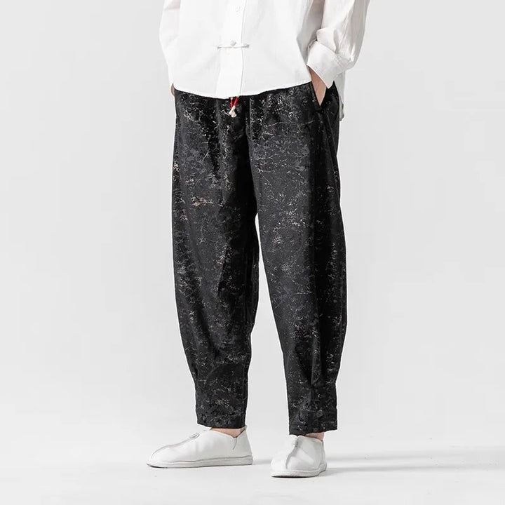 Crushed velvet joggers with an oversized fit, elastic cuffs, and drawstring waist, showcasing a sleek texture and sheen.