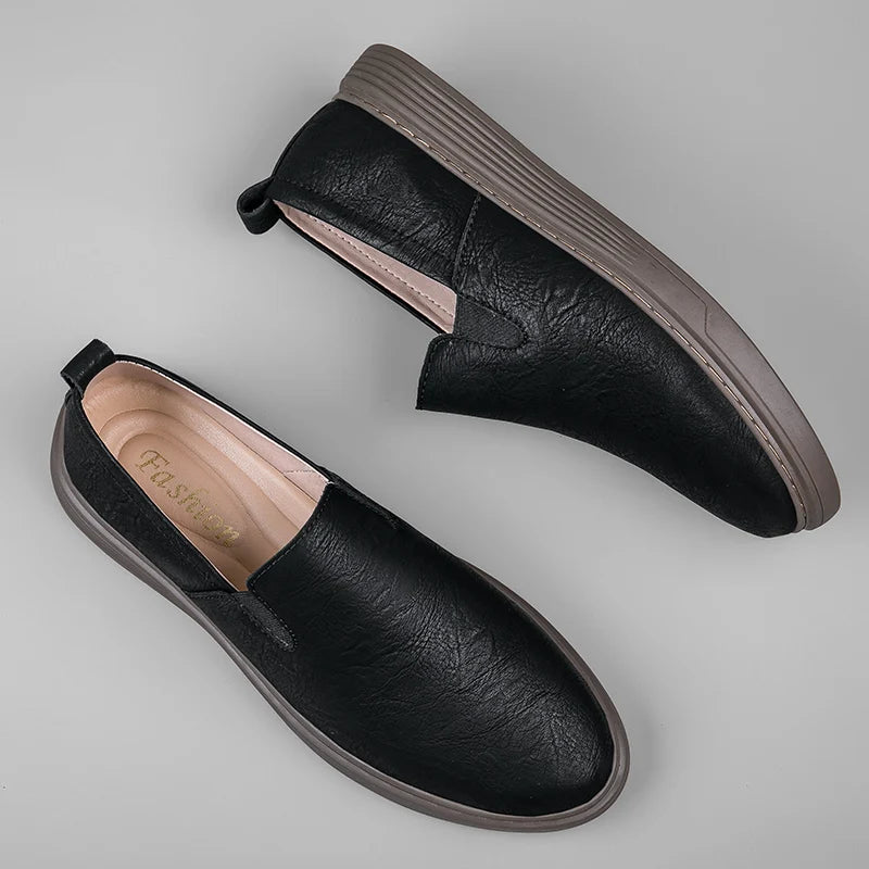 Duke Leather Slip-On Shoes in sleek black, featuring a cushioned sole and elastic side panels for comfort.