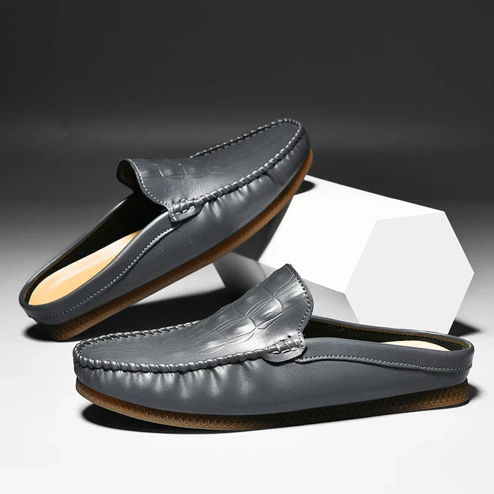 Gianni backless slide loafers in gray with embossed upper and moc toe for style and comfort.