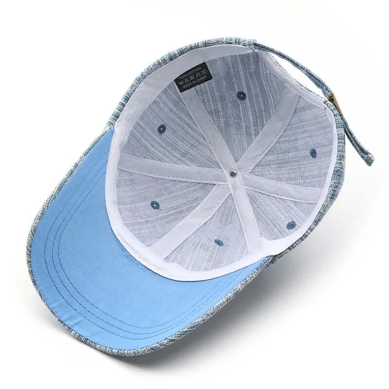 Interior view of Wyatt Street Denim Cap showing cotton fabric, adjustable strap, and ventilation details.