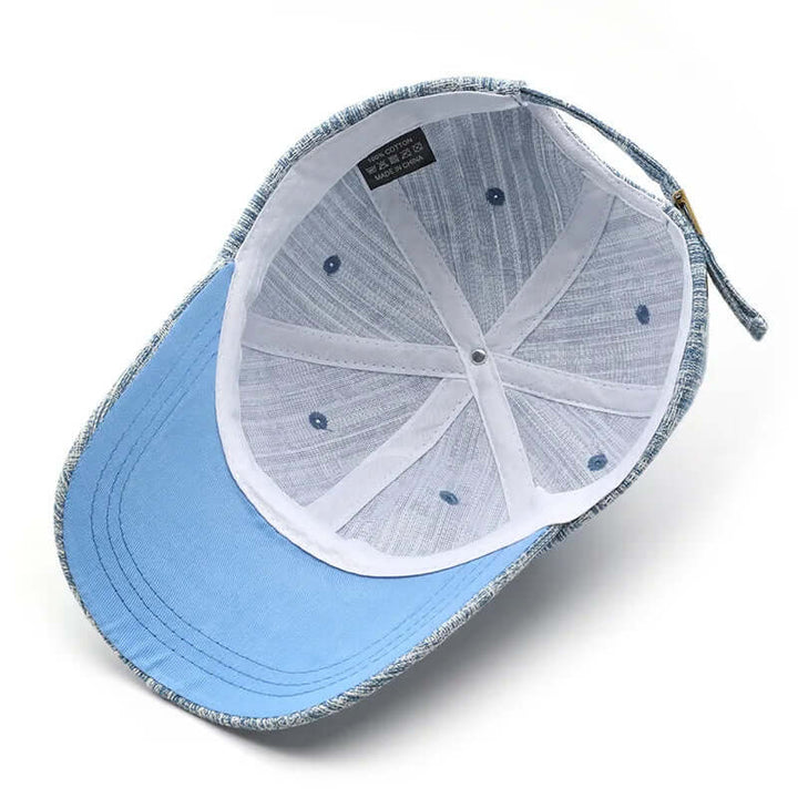Interior view of Wyatt Street Denim Cap showing cotton fabric, adjustable strap, and ventilation details.
