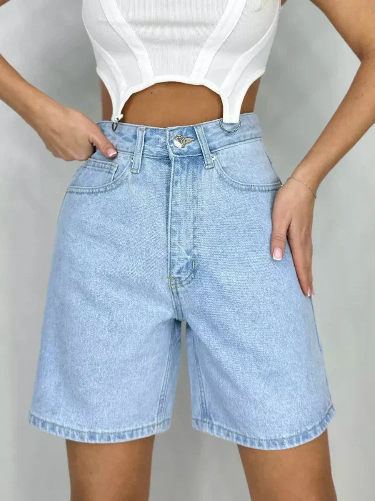 Bella Y2K high waist jean shorts in light wash with rolled cuffs and classic 5-pocket styling for a vintage-inspired look.