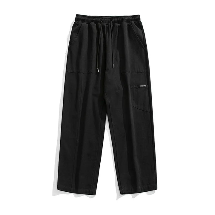 Huxley Men's black 100% cotton cargo pants with oversized pockets and adjustable drawstring waist.