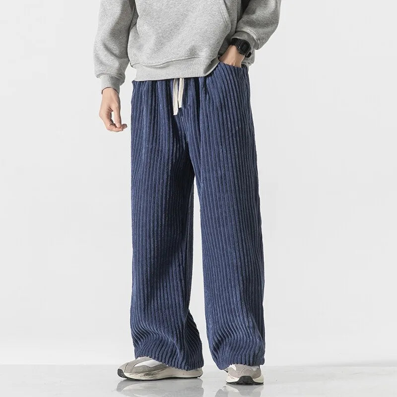 Young adult wearing Barron Corduroy Pants with wide-leg fit and elastic waistband, styled casually with a grey sweatshirt.