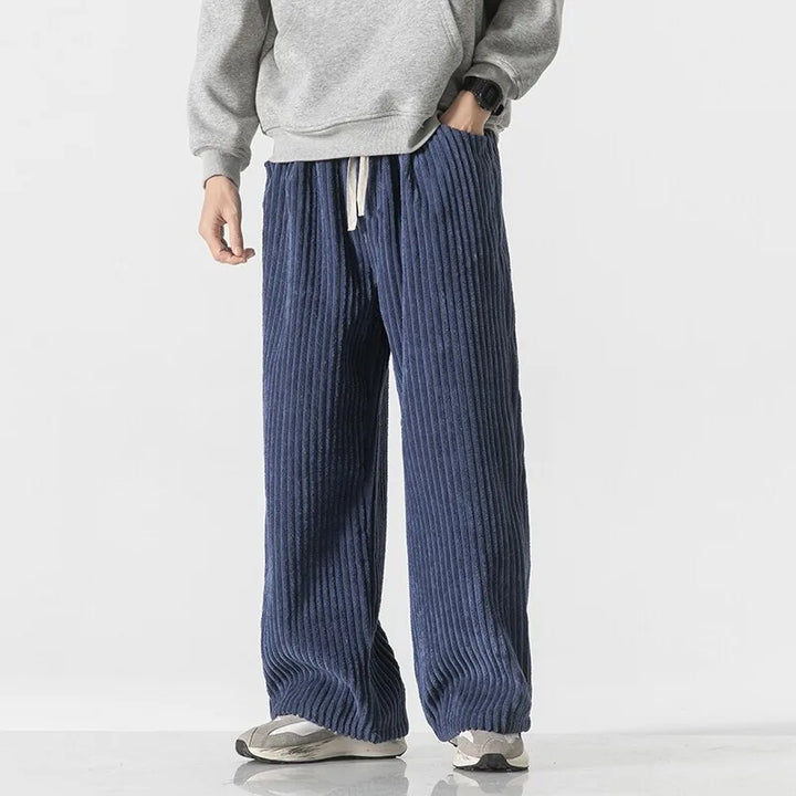 Young adult wearing Barron Corduroy Pants with wide-leg fit and elastic waistband, styled casually with a grey sweatshirt.