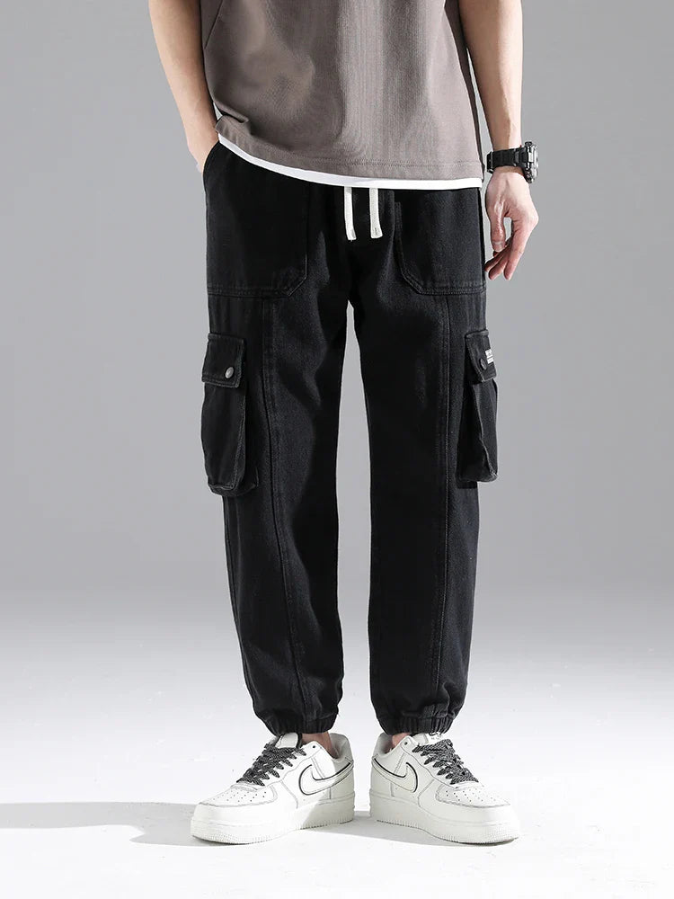 Lennox Cargo Joggers in black with oversized pockets, relaxed fit, elastic cuffs, and adjustable drawstring waist.