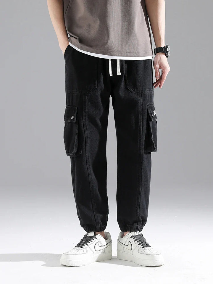 Lennox Cargo Joggers in black with oversized pockets, relaxed fit, elastic cuffs, and adjustable drawstring waist.