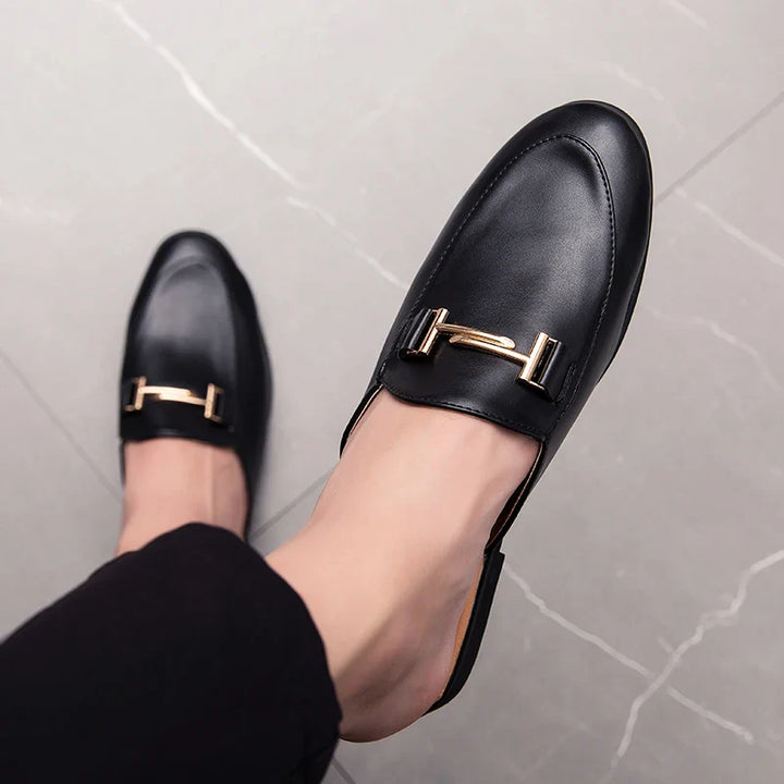Santino Backless Slide Loafers featuring a sleek black design and gold bit hardware, perfect for effortless style.