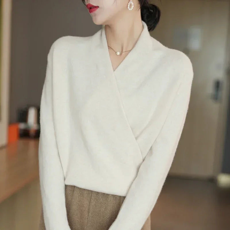 Crossover wool sweater in soft cream with a wrap-front design, perfect for effortless style and cozy comfort.