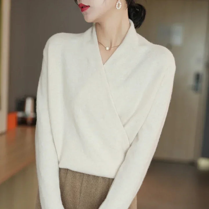 Crossover wool sweater in soft cream with a wrap-front design, perfect for effortless style and cozy comfort.