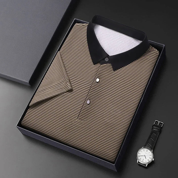 Eden Striped Polo neatly packaged in a box with a black contrast collar and a stylish wristwatch beside it.
