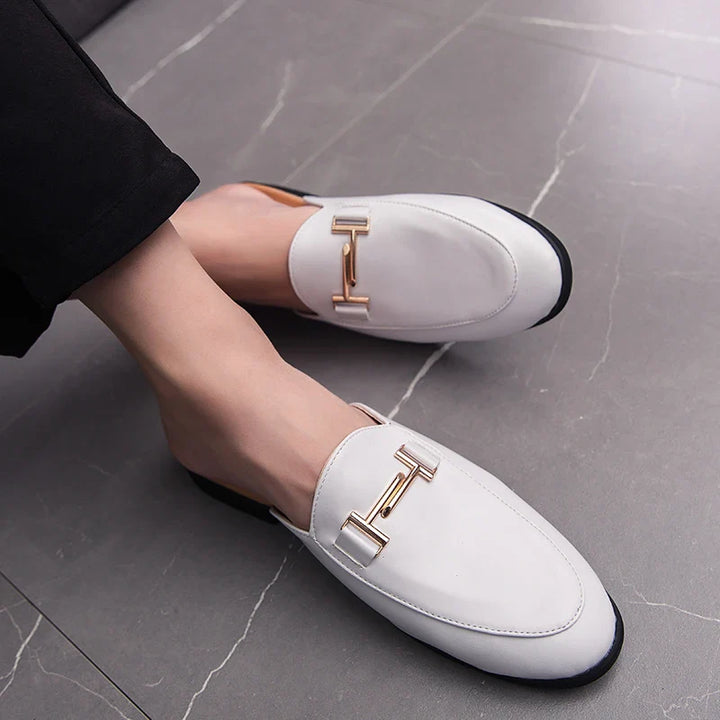 Santino Backless Slide Loafers in white with gold bit hardware, showcasing a sleek, polished design and open-back style.