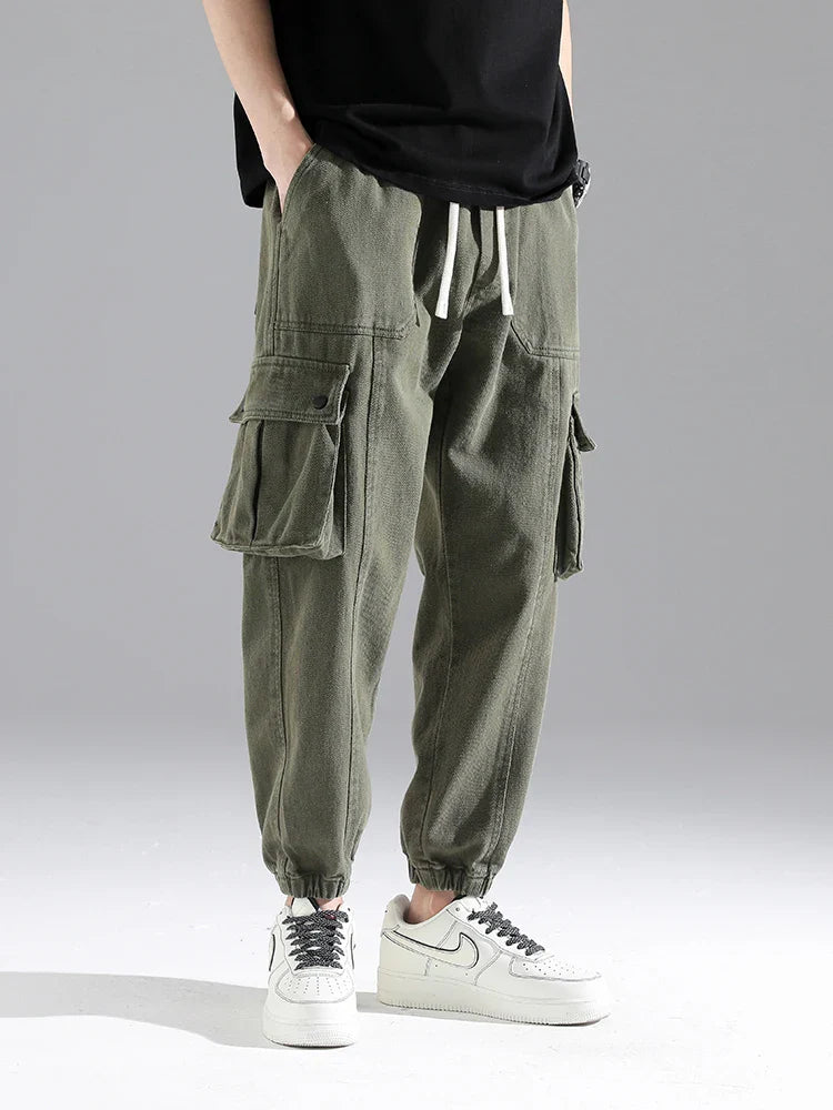 Lennox Cargo Joggers in heavyweight cotton blend with snap pockets and elastic cuffs, showcasing relaxed tapered fit.