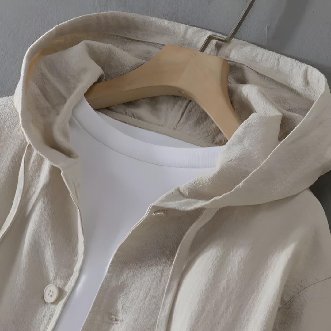 Close-up of Element Linen Hoodie featuring a light beige color, spacious hood, and smooth button closure on a hanger.