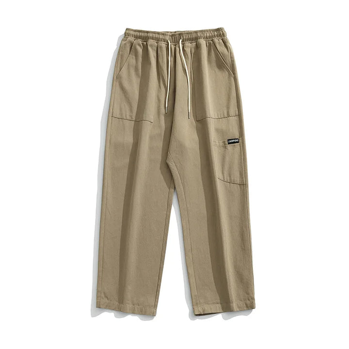 Huxley Men's 100% Cotton Cargo Pants with oversized pockets and drawstring waist in beige color.