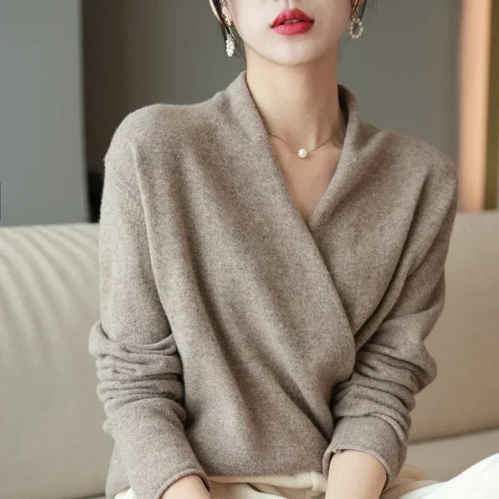 Crossover wool sweater in soft beige, featuring an elegant wrap-front design for a relaxed fit and stylish comfort.