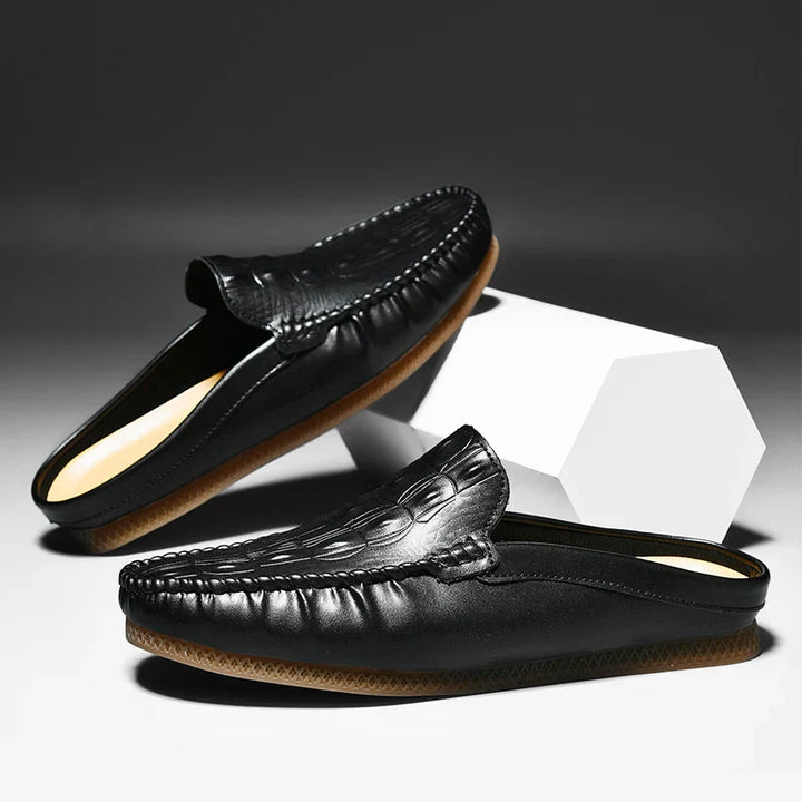 Gianni backless slide loafers in black with embossed upper and classic moc toe design for stylish comfort.
