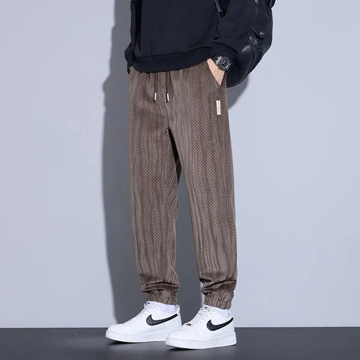 Riden checkered corduroy pants featuring soft brushed interior, tapered fit, and adjustable waistband for comfort.