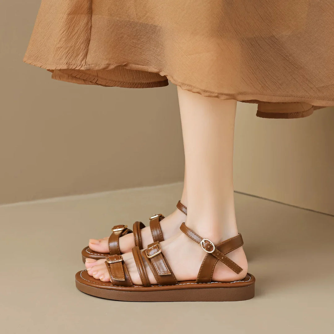 Luna Leather Flat Sandals with soft straps and cushioned footbed, featuring triple buckle closures for a comfortable fit.