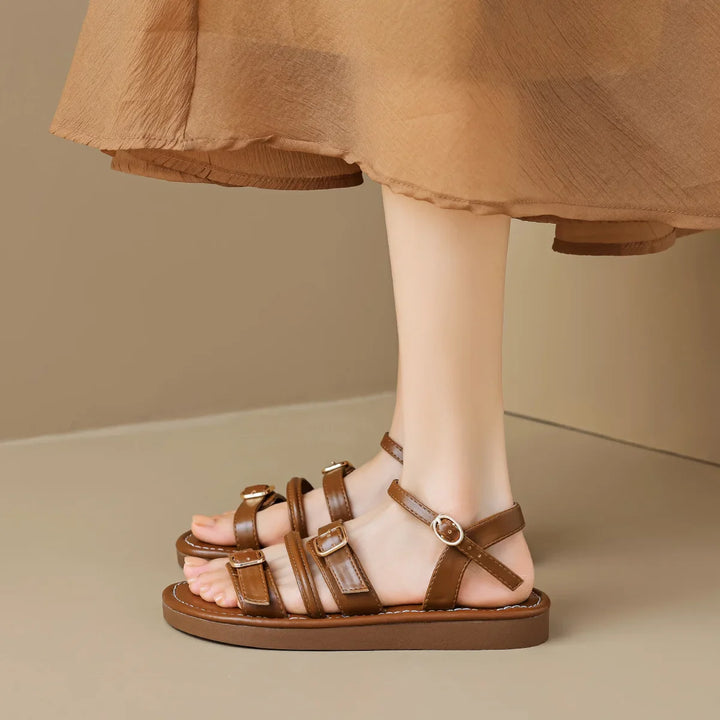 Luna Leather Flat Sandals with soft straps and cushioned footbed, featuring triple buckle closures for a comfortable fit.