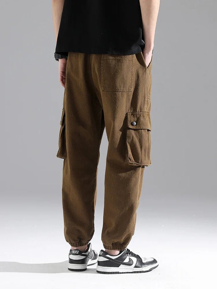Lennox Cargo Joggers in brown, featuring oversized pockets, gathered cuffs, and a relaxed tapered fit.