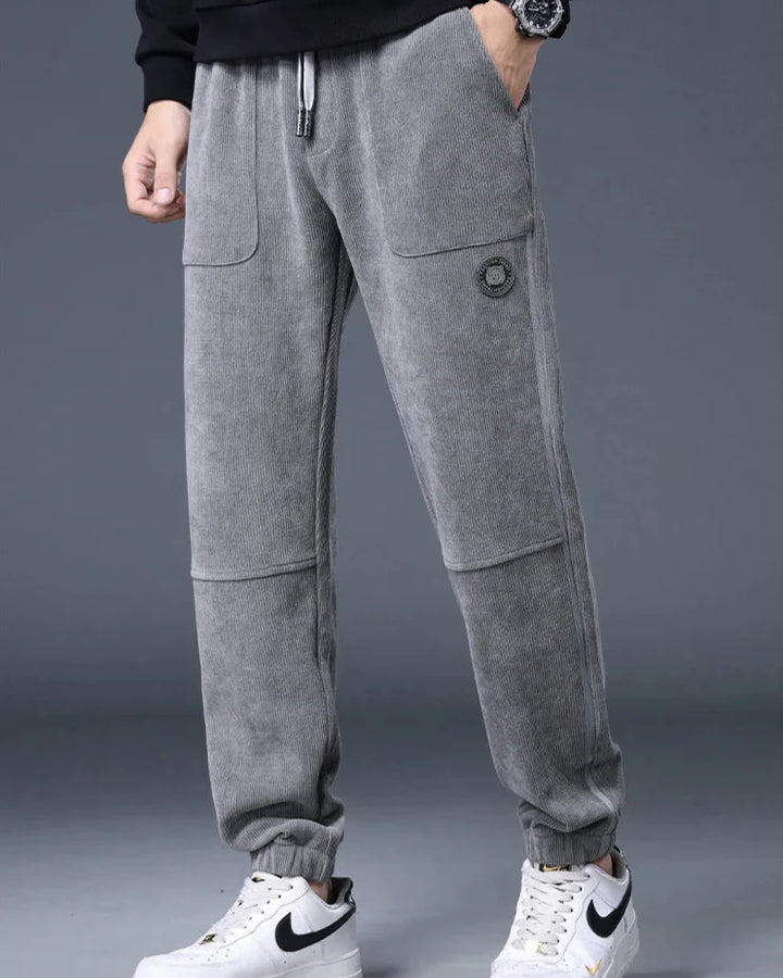 Amos Grey Corduroy Joggers with relaxed tapered fit, large pockets, and adjustable drawstring waist.