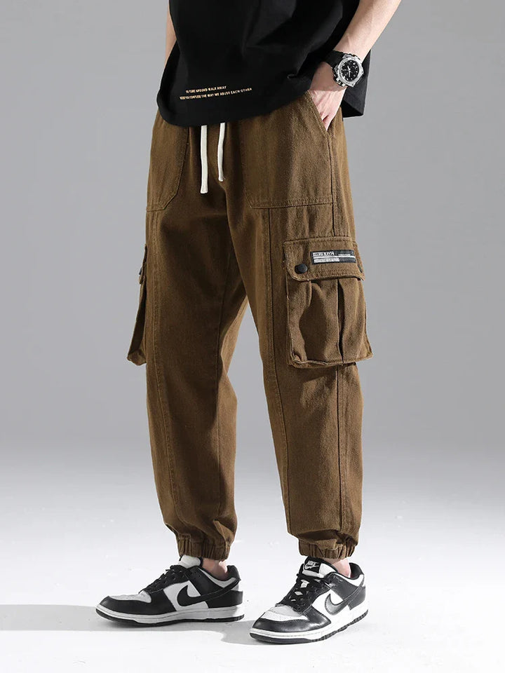 Lennox Cargo Joggers in brown, featuring oversized pockets, elastic cuffs, and adjustable drawstring waist for a relaxed fit.