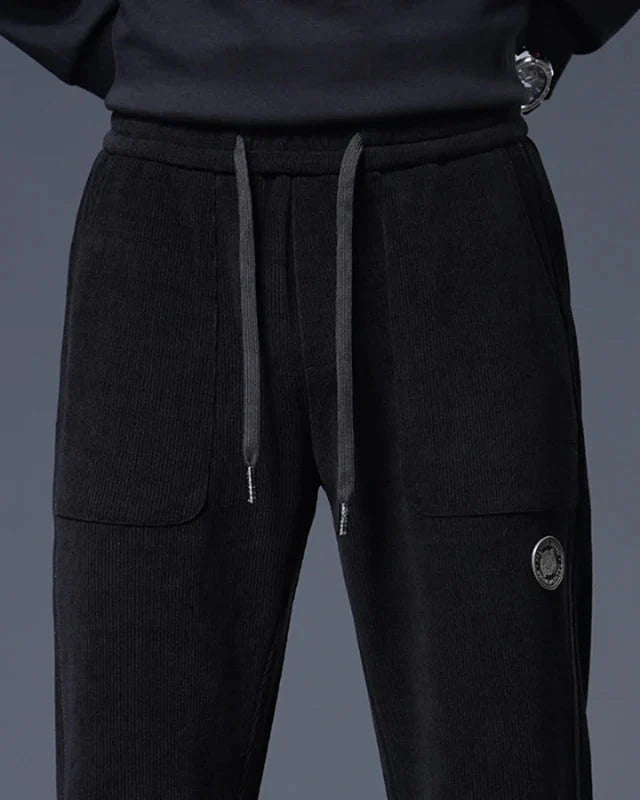 Amos Corduroy Joggers featuring wide-wale corduroy, relaxed tapered fit, adjustable drawstring, and large pockets.
