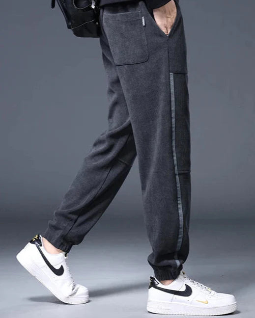 Men's Amos Corduroy Joggers in dark gray with wide-wale corduroy, relaxed tapered fit, and functional pockets.