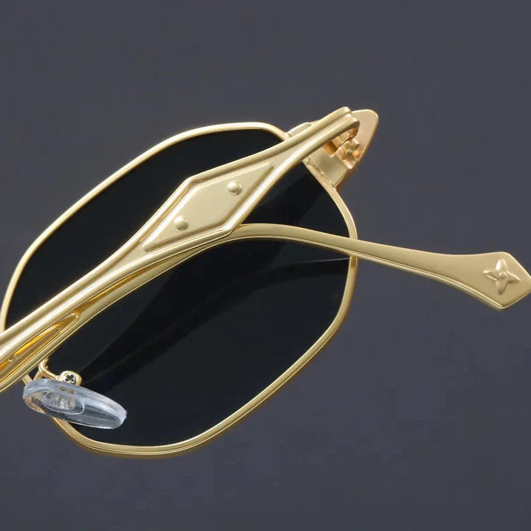 Stylish Atlas Alloy sunglasses featuring geometric frames and sculpted gold metal arms for a standout look.